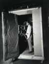 Cameraman inside soundproof camera booth ca. 1926