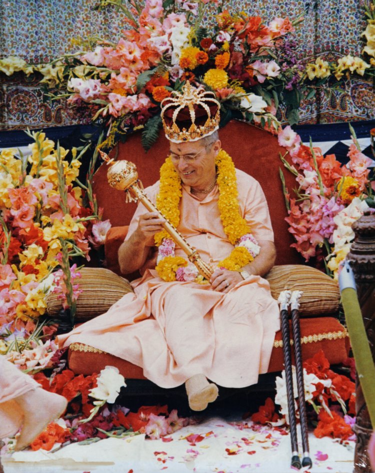 Bhaktipada wears a gold crown and admires a mace crafted by master jeweler Mother Ishani (Ellen Schramm) given to him at his 49th birthday celebration (New Vrindaban, September 1986)
