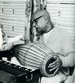 Prabhupada plays the mrdanga